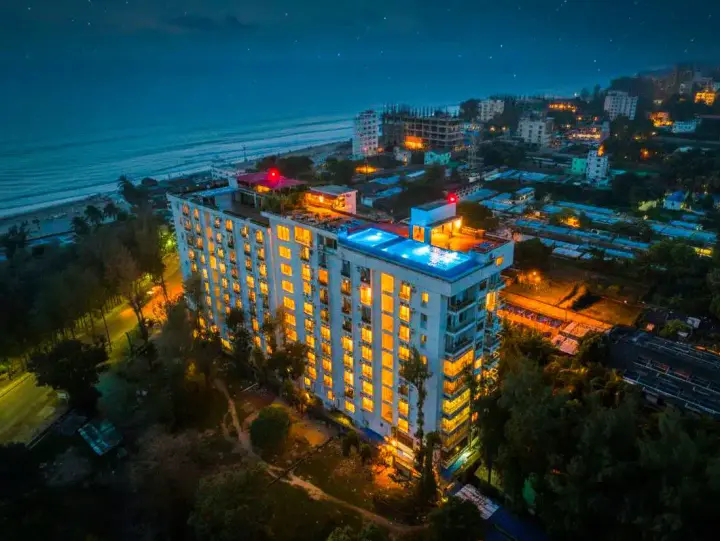 Neeshorgo Hotel lit up at night on Marine Drive