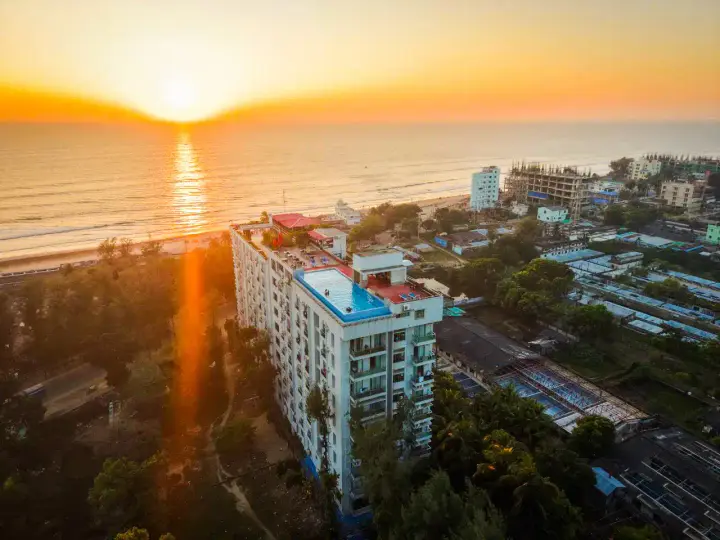 Neeshorgo Hotel at sunset with the Bay of Bengal behind